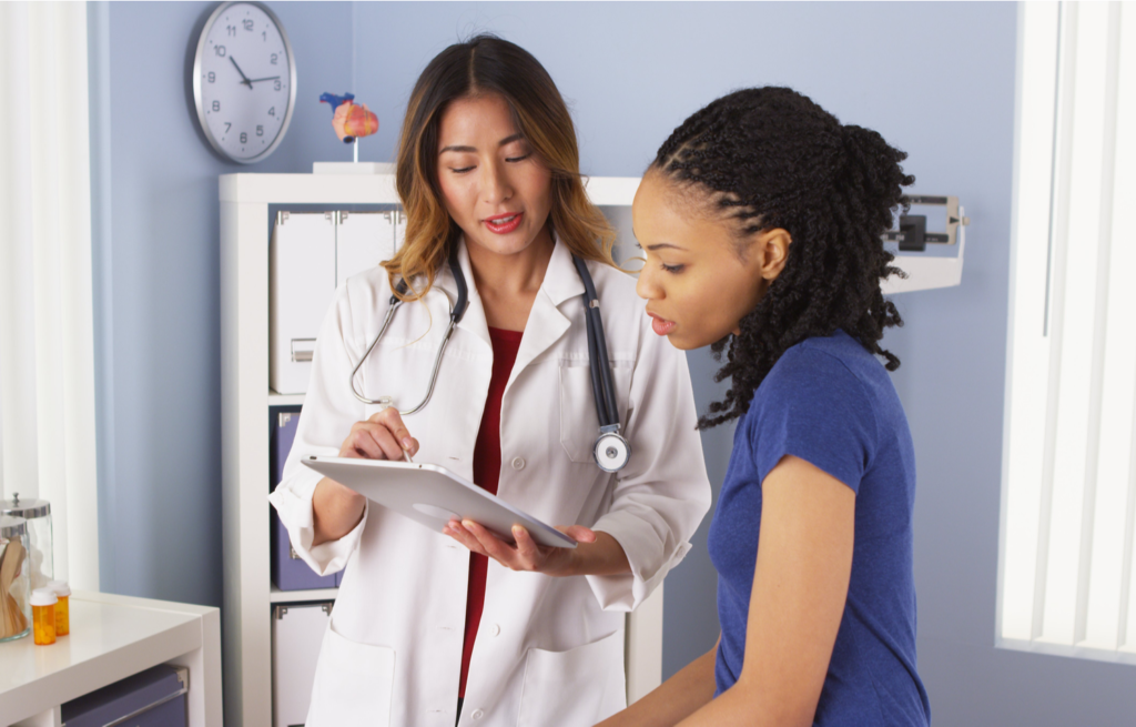 A doctor explains screening results to a patient